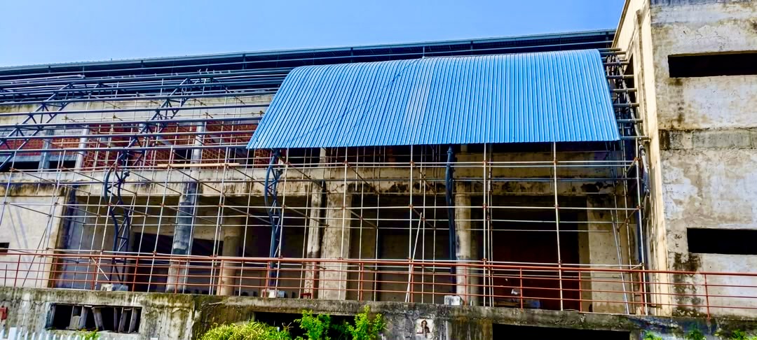 Freedom Centre building exterior showing completed blue aluminium roof sections
